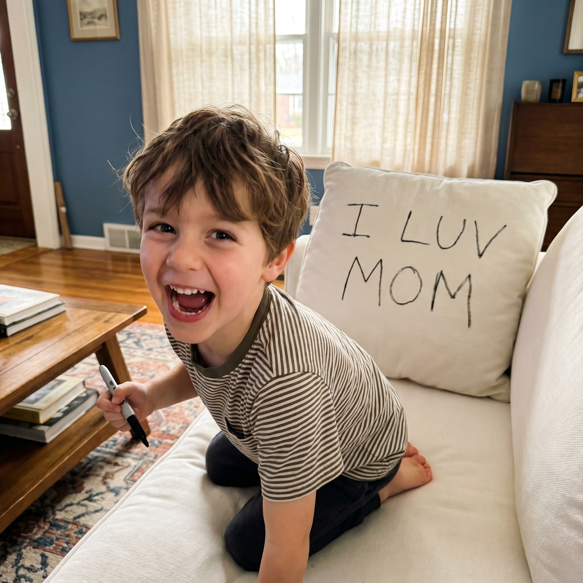 A child wrote I love mom on the couch